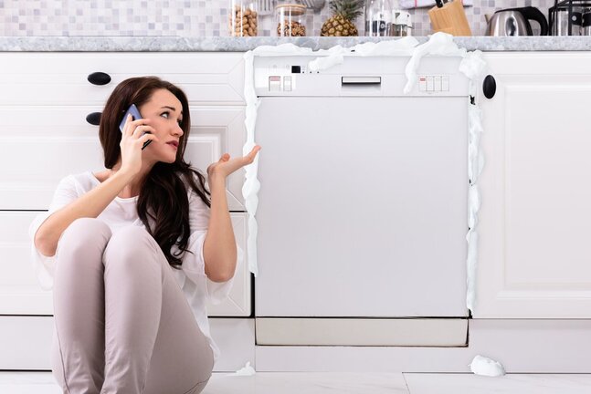 woman calling for dishwasher repair